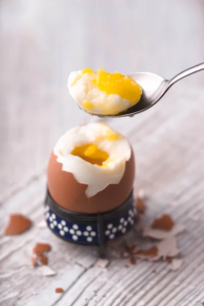 Soft-boiled egg on the white wooden table vertical — Stock Photo, Image