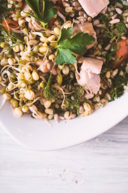 Tavuk ve beyaz bir tablo üzerinde bir kase içinde fasulye salatası