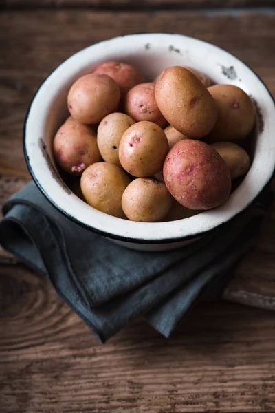 Rohe Kartoffeln rot und weiß in Schüssel auf Serviette — Stockfoto