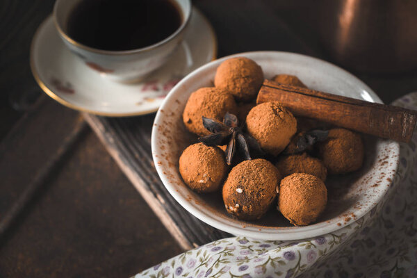 Chocolate truffle and coffee on the wooden table horizontal