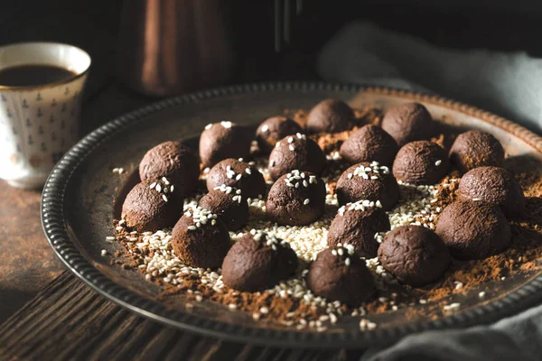 Chocolate truffles with sesame on the metal plate horizontal — Stock Photo, Image