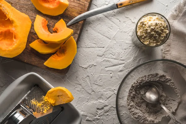 Pumpkin, flour on a white table for making pancakes Stock Photo