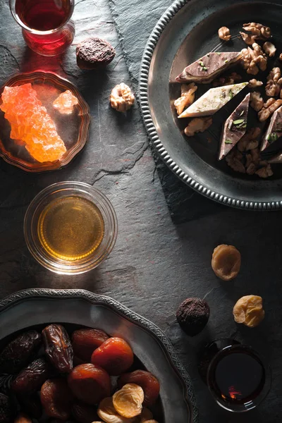 Dried fruits, grape sugar and tea on a gray slate diagonal — Stock Photo, Image