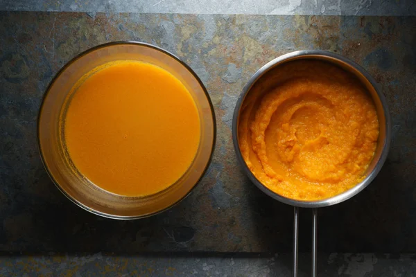 Pumpkin soup in a glass bowl and sauerkraut with pumpkin puree — Stock Photo, Image