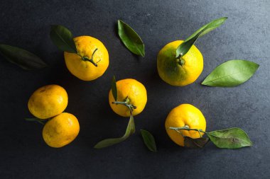 Gri bir taş üzerinde taze sarı mandalina