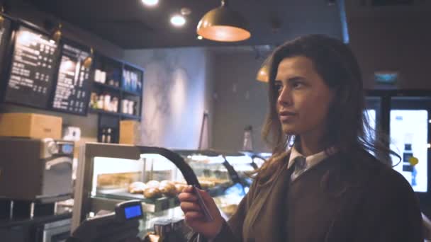 Молодая красивая девушка в кафе ходит по магазинам — стоковое видео
