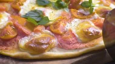 Pizza margarita bir yan görünüme bir bıçak ile kesmek. Video