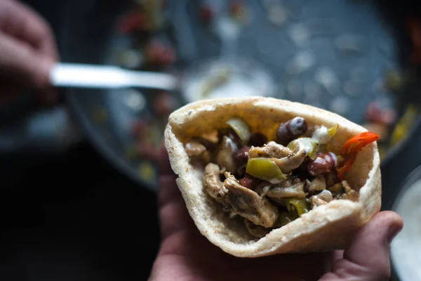 Man is stuffed with tortilla stuffing for fajita partial blurring close-up — Stock Photo, Image