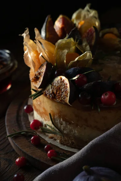 Cheesecake with physalis and dates and wild berries — Stock Photo, Image
