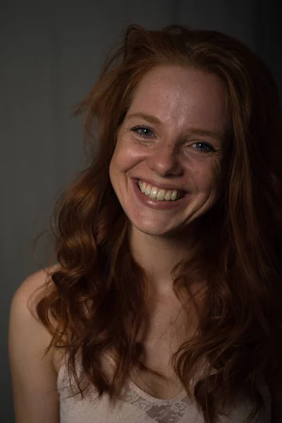 Portrait of a young, beautiful, red-haired woman who laughs — Stock Photo, Image