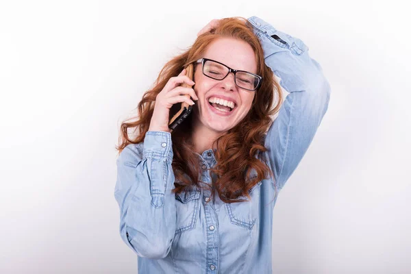 Attractive redheaded woman is laughing during a phone call — Stock Photo, Image