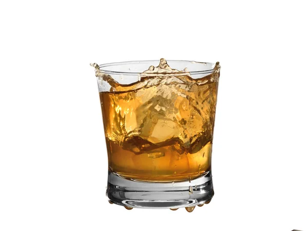 Whiskey splash in a glass isolated on white background