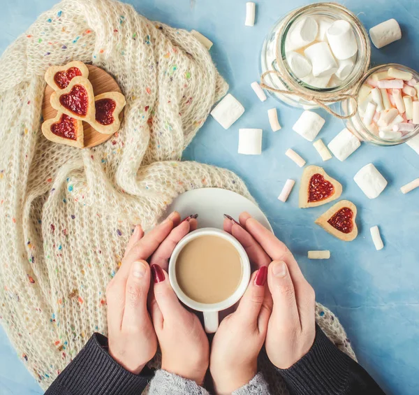 Kakao ve çerezleri kalp aşıkların elinde. Seçici odak. 