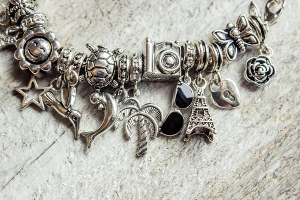 Bracelet with pendants charms on the summer theme. Selective focus. — Stock Photo, Image