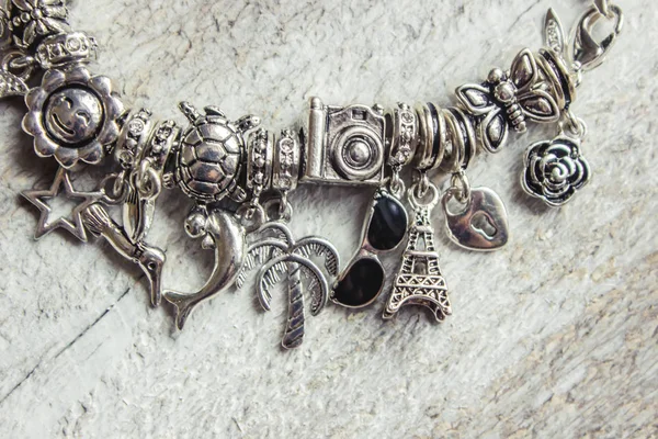 Bracelet with pendants charms on the summer theme. Selective focus. — Stock Photo, Image