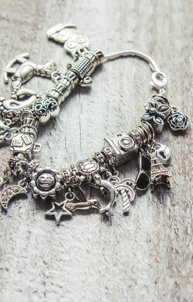 bracelet with pendants charms on the summer theme. Selective focus.