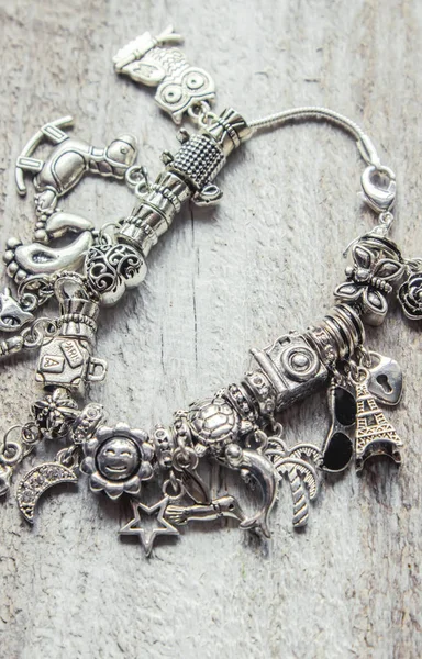 Bracelet with pendants charms on the summer theme. Selective focus. — Stock Photo, Image