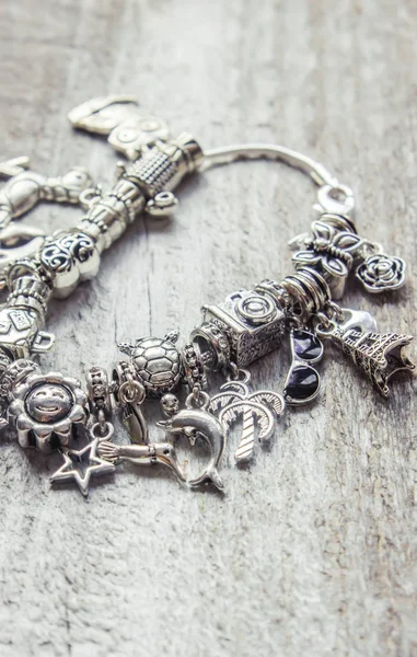 Bracelet with pendants charms on the summer theme. Selective focus. — Stock Photo, Image