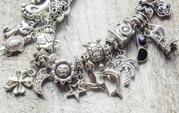 Bracelet with pendants charms on the summer theme. Selective focus. — Stock Photo, Image