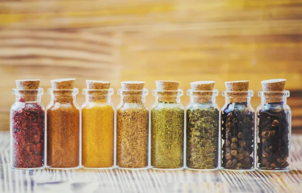 Spices in jars on wooden background. selective focus. — Stock Photo, Image