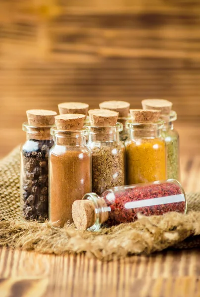 Spices in jars on wooden background. selective focus. — Stock Photo, Image
