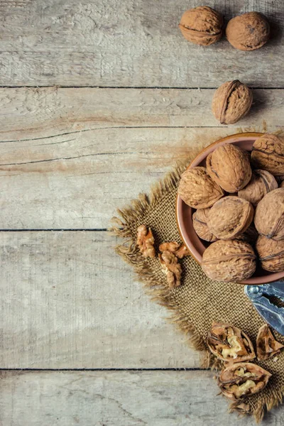 Walnuts on wooden background. Selective focus. — Stock Photo, Image