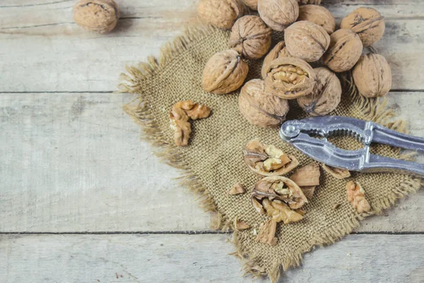 Walnuts on wooden background. Selective focus. — Stock Photo, Image