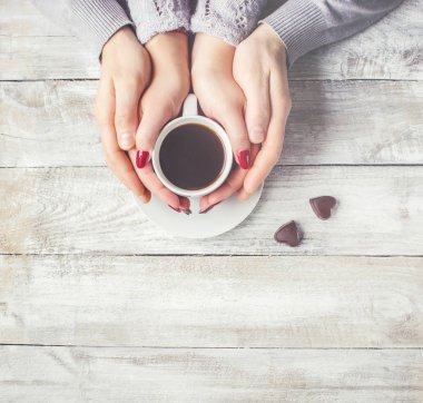 Aşıkların elinde kahvaltı için bir bardak içki. Seçici odak. 