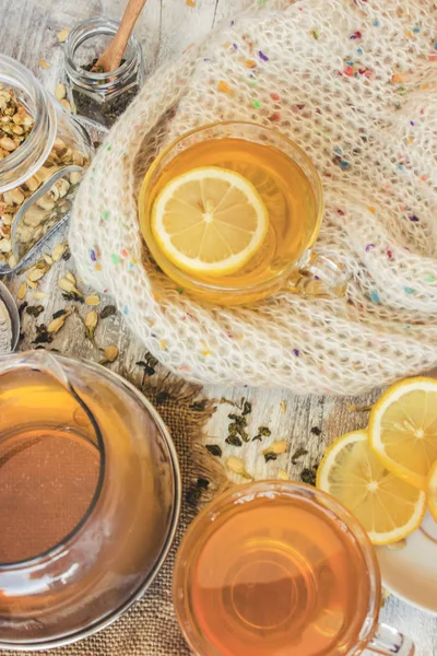 Green tea with Jasmine and black with transparent lemon in a small Cup on a light background. The tea maker. Selective focus. — Stock Photo, Image