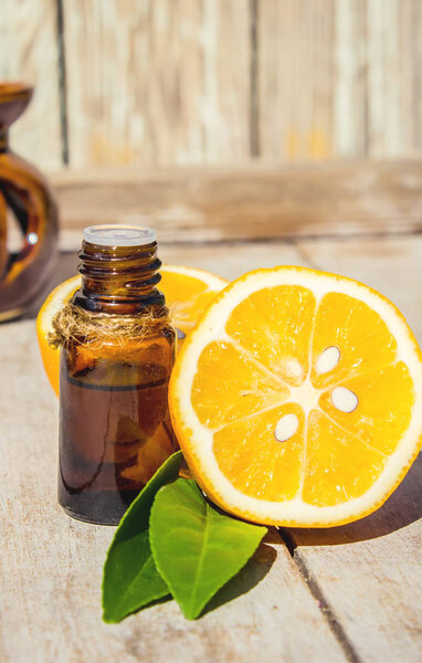 Lemon essential oil in a small bottle. Selective focus. 