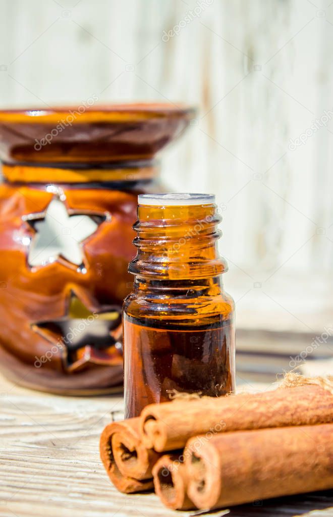 Essential oil of cinnamon and star anise in a small bottle. 