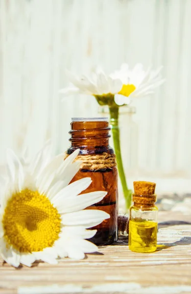 Chamomile essential oil in a small bottle. Selective focus. — Stock Photo, Image