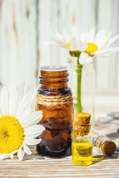 Aceite esencial de manzanilla en una botella pequeña. Enfoque selectivo . — Foto de Stock