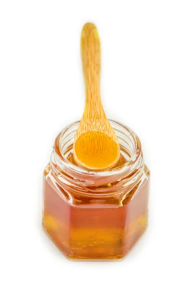 Μέλι σε ένα λευκό φόντο. επιλεκτική εστίαση. — Φωτογραφία Αρχείου