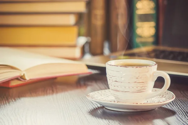 Kaffe morgonen på arbetsplatsen. med en bok eller laptop. selektivt fokus. — Stockfoto