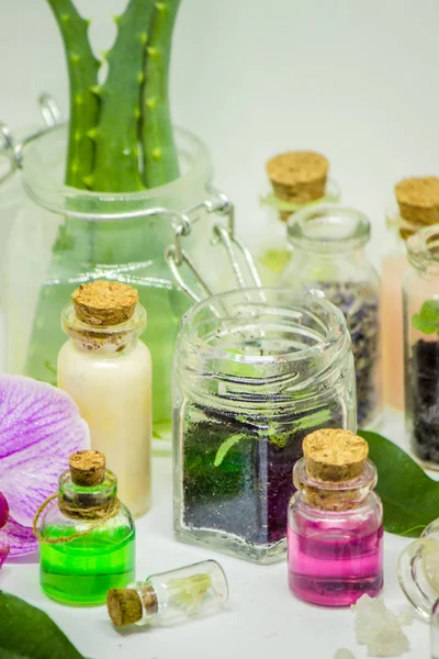 Flowers and plant extracts in small bottles. Selective focus.