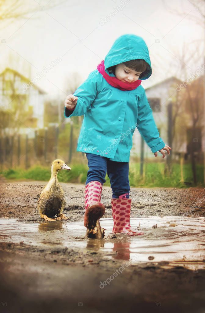 Girl with a duck on his arm. Selective focus. 