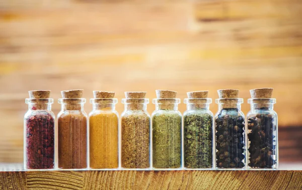 Spices in jars on wooden background. selective focus. — Stock Photo, Image