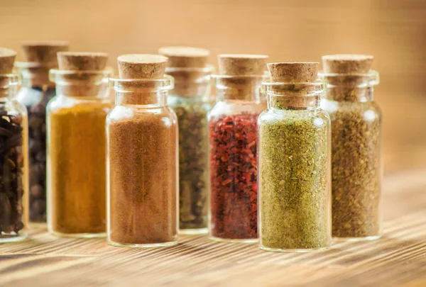 Spices in jars on wooden background. selective focus. — Stock Photo, Image