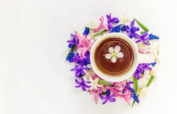 Spring background, flowers and tea. Selective focus.