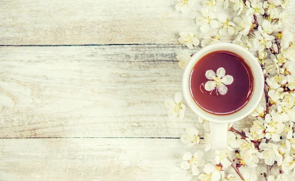 Spring background, flowers and tea. Selective focus.