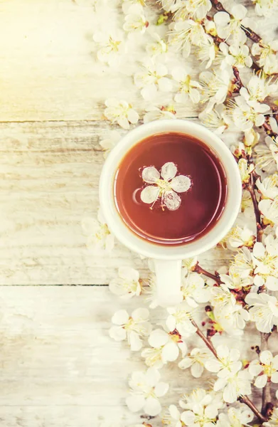 Spring background, flowers and tea. Selective focus.