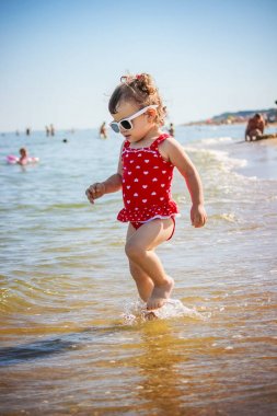 Bebek kız sahilde deniz kenarında. Seçici odak.