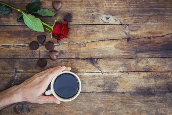 Coffee in hand. The lovers are together. Selective focus.