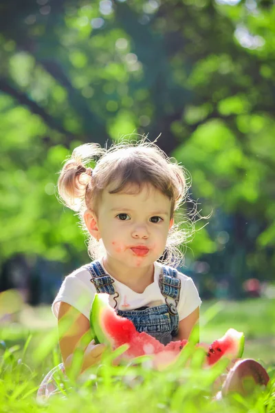 A child eats watermelon. Selective focus. — Stock Photo, Image