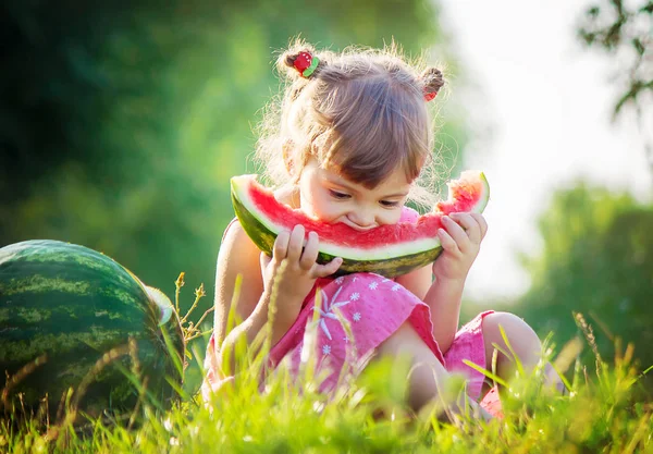 Een kind eet watermeloen. Selectieve aandacht. — Stockfoto