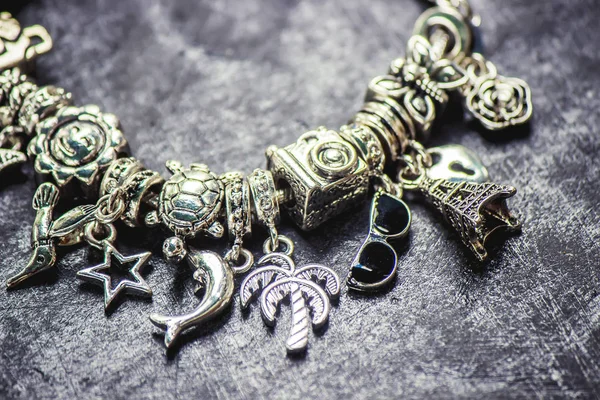 Bracelet with charms. selective focus. — Stock Photo, Image