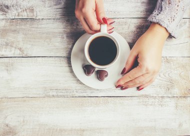 Bir fincan kahve bir kadın elinde. Seçici odak.