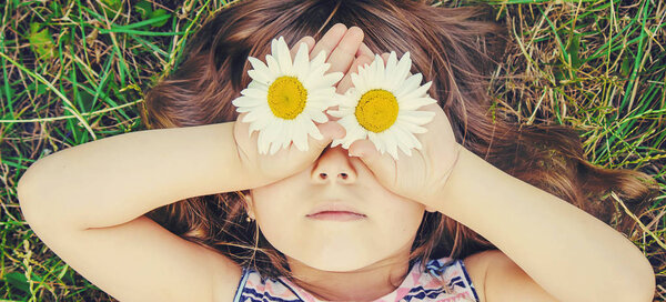 Girl with daisies. Selective focus. 