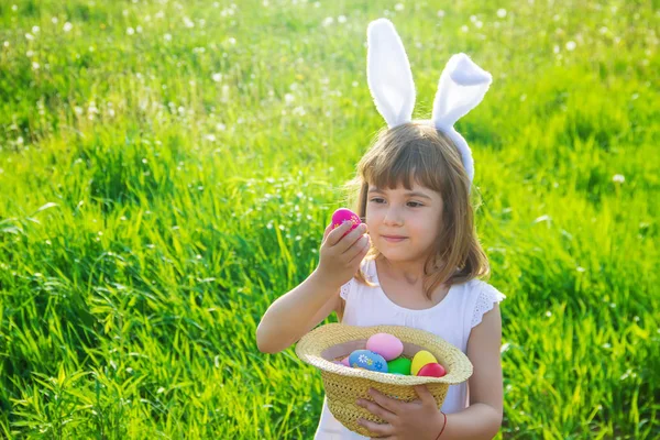Child with rabbit ears. Easter. Selective focus.